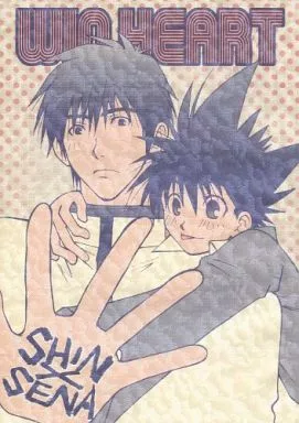 The cover for Win Heart, which shows Sena sticking his tongue out while reaching over a mildly surprised Shin's shoulder with an open palm, which has the title written on it.